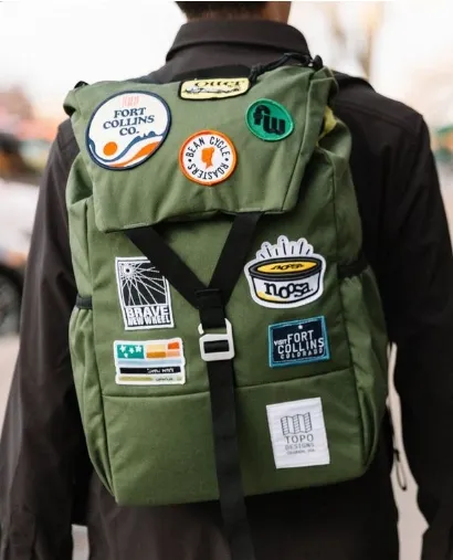 Patch-covered green backpack