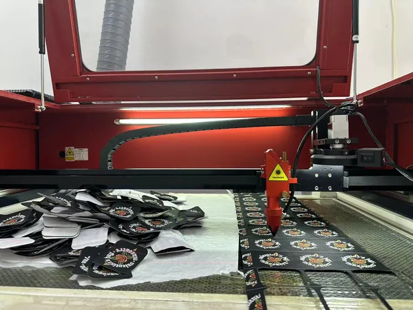 Laser cutting embroidered patch shapes